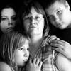 Michelle Butts, center, and her children, from left, Stephanie Hilaman, 21; Lisa Butts, 12; and Dennis Butts, 15, are shown this summer at their Mountain Grove, Mo., home.