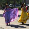 Dressed in traditional attire, four ladies dance to Latin music as they make their way down Water Street for the annual Hispanic International Day Parade.
