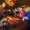 Mark Swiecionis deals to Melda Heeg and her daughter Lori, both of Illinois, at a Pai Gow table at Sunset Station in Henderson Oct. 27, 2011. Station Casino's have linked their Pai Gow tables to enable progressive jackpots.