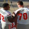 Las Vegas natives and UNLV linemen Ron Scoggins checks the lettering on teammate Aleks Vekic before having their team photo taken for the Heart of Dallas Bowl Tuesday, Dec. 31, 2013 at the Cotton Bowl in Dallas. Las Vegas natives and UNLV linemen Ron Scoggins checks the lettering on teammate Aleks Vekic before having their team photo taken for the Heart of Dallas Bowl Tuesday, Dec. 31, 2013 at the Cotton Bowl in Dallas.