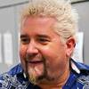 Guy Fieri works a patio grill at The Quad helping to serve burgers to fans outside his first Las Vegas restaurant, Guy Fieri's Vegas Kitchen & Bar on Friday, April 4, 2014. Guy Fieri works a patio grill at The Quad helping to serve burgers to fans outside his first Las Vegas restaurant, Guy Fieri's Vegas Kitchen & Bar on Friday, April 4, 2014.