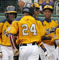 Chicago's Trey Hondras (24) is greeted by teammates after hitting a two-run home run off Las Vegas' Brennan Holligan in the first inning of a United States Championship game at the Little League World Series tournament in South Williamsport, Pa., Saturday, Aug. 23, 2014. (AP Photo/Gene J. Puskar Chicago's Trey Hondras (24) is greeted by teammates after hitting a two-run home run off Las Vegas' Brennan Holligan in the first inning of a United States Championship game at the Little League World Series tournament in South Williamsport, Pa., Saturday, Aug. 23, 2014. (AP Photo/Gene J. Puskar