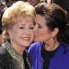 Debbie Reynolds, left, and Carrie Fisher arrive at the Primetime Creative Arts Emmy Awards on Saturday Sept. 10, 2011 in Los Angeles. (AP Photo/Chris Pizzello)