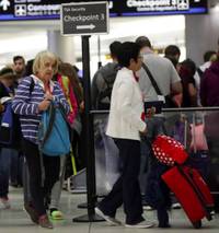 America's busiest airport, Atlanta's Hartsfield-Jackson International, is a blur of activity on the best of days. But an extra layer of anxiety gripped the airport Friday, the eve of a three-day holiday weekend. The partial government ...