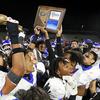 Bishop Gorman players celebrate with their trophy after beating Liberty, 56-14, in the Class 5A Southern Region football final at Liberty High School in Henderson, Friday, Nov. 11, 2022. 