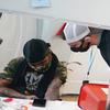 Brian Hackel, right, an overdose prevention specialist, helps Steven Baez, a client suffering addiction, find a vein to inject intravenous drugs at an overdose prevention center, OnPoint NYC, in New York, Feb. 18, 2022.