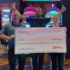 Jesus, center, receives his $10.5 million winnings from a Megabucks slot machine from Mike Conors, Boyd Gaming director of operations and Nicole Stuart, director of marketing at Cannery Casino & Hotel in Las Vegas on Friday, July 7, 2023.