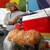 Street vendor Luis Sanchez waits for customers by his mobile food stand in a residential neighborhood  in North Las Vegas Wednesday, June 14, 2023. Senate Bill 92, signed by Governor Lombardo last week, legitimizes street vendors across the state, providing them with the necessary permits to operate and grow their small businesses.