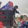 In this image from video provided by Stringr, festival goers are helped off a truck from the Burning Man festival site in Black Rock, Nev., on Monday, Sept. 4, 2023. An unusual late-summer storm stranded thousands at the week-long event.