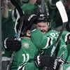 Dallas Stars' Logan Stankoven (11), Evgenii Dadonov, second from left, and Wyatt Johnston (53) celebrate a goal by Dadonov as Vegas Golden Knights' Jack Eichel (9) skates past in the first period in Game 5 of an NHL hockey Stanley Cup first-round playoff series in Dallas, Wednesday, May 1, 2024. 