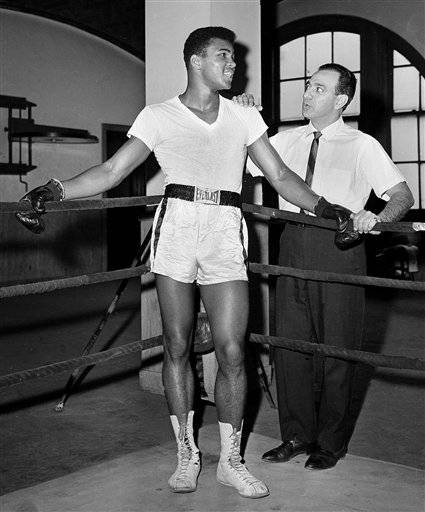 In this Feb. 8, 1962, file photo, young heavyweight fighter Cassius Clay, who later changed his name to Muhammad Ali, is seen with his trainer Angelo Dundee at City Parks Gym in New York. Ali turned 70 on Jan. 17, 2012. 