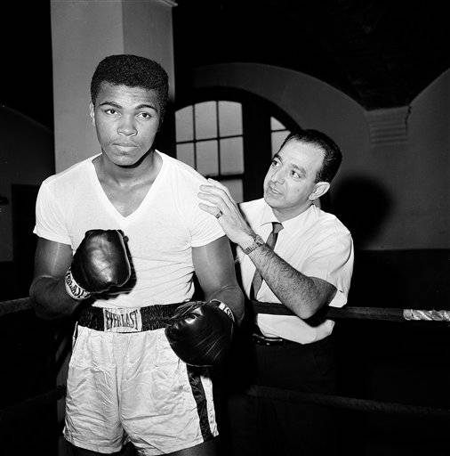 In this Feb. 8, 1962, file photo, a young Muhammad Ali is seen with his trainer Angelo Dundee at City Parks Gym in New York. The three-time heavyweight boxing champion will celebrate a milestone birthday Tuesday, Jan. 17, 2012, when he turns 70.