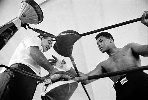 World heavyweight champion Muhammad Ali gets his hand taped by his manager Angelo Dundee before a sparring session in Miami Beach, Fla., on Oct. 13, 1966. 