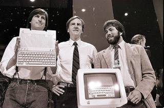 In this April 24, 1984 file photo, Steve Jobs, left, chairman of Apple Computers, John Sculley, center, then president and CEO, and Steve Wozniak, co-founder of Apple, unveil the new Apple IIc computer in San Francisco. Apple Inc. on Wednesday, Aug. 24, 2011 said Jobs is resigning as CEO, effective immediately. He will be replaced by Tim Cook, who was the company's chief operating officer. It said Jobs has been elected as Apple's chairman.