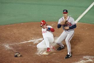Phillies runner John Kruk scores in a wild pitch in the sixth inning as Atlanta Braves pitcher Steve Avery waits for the throw from catcher Damon Berryhill in game one of the league championship series at Veterans Stadium in Philadelphia, Wednesday, Oct. 6, 1993. 