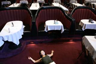 Aki Kanayama stretches in the empty showroom during the rehearsal of 