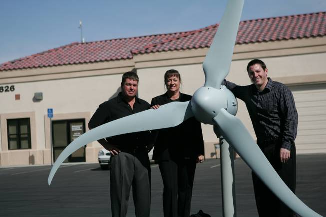 From right, Allen McLane and Nancy Tabor, co-owners of McLane Electric, and project manager Jason McLane, pose with a demonstration version of a Skystream wind turbine at their warehouse.