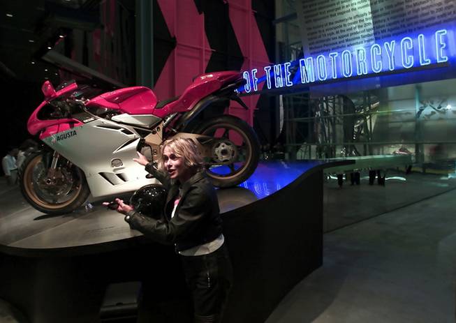 Actress Lauren Hutten points to a motorcycle during pre-opening festivities for the Guggenheim Las Vegas museum at The Venetian hotel-casino Thursday, October 4, 2001. The inaugural exhibit at the new museum is "The Art of the Motorcycle".  The 63, 700 sq. ft. exhibition hall opens to the public Sunday.