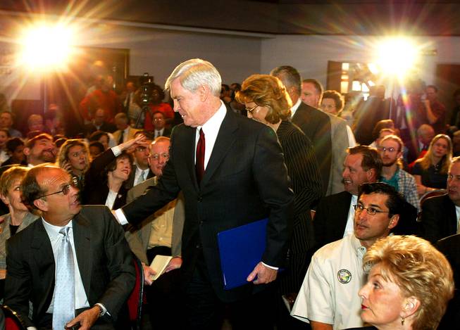 Mandalay Bay Resort Group executive Mike Sloan, left, is greeted by Nevada Gov. Kenny Guinn as he makes his way to the podium before his Yucca Mountain veto speech Monday, April 8, 2002 at UNLV.