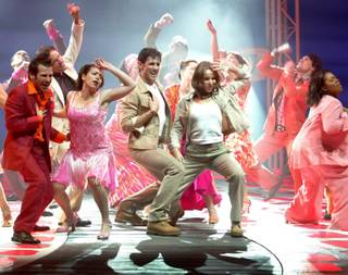Sky (played by Victor Wallace) and his fiancee Sophie Sophie (played by Jill Paice) ,center, dance during a scene in the musical Mama Mia at the Mandalay Bay Sunday February 2, 2003.