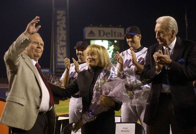 New York Mets announcer Bob Murphy, left. acknowledges fans as his wife Joye, fellow broadcaster Ralph Kiner, right, pitchers John Franco and Al Leiter applaude at a ceremony to celebrate his career as the with the Mets before a game against the  Pittsburgh Pirates at Shea Stadium in New York, Thursday, Sept. 25, 2003. Murphy, the Mets announcer since 1962, will retire after tonights game.