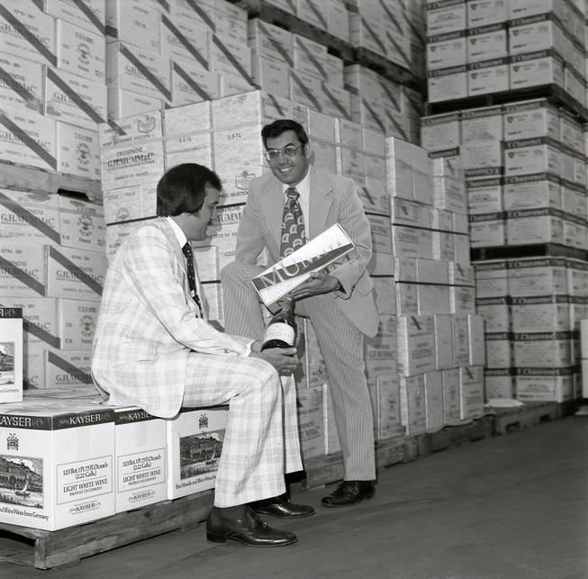 Larry Ruvo, left, and Jerry Vallen look over a bottle of wine at the SWS warehouse for the first ever UNLVino event in that took place in 1974.