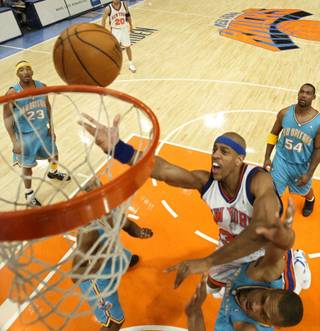 New York Knicks' Jerome Williams puts up a shot against New Orleans Hornets' P. J. Brown during the first quarter Tuesday, Jan. 11, 2005 at Madison Square Garden in New York. The Hornets won 88-82. 