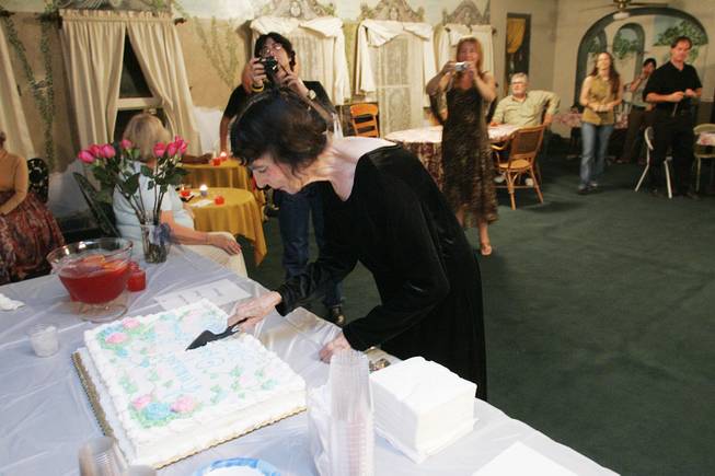 Marta Becket cuts a celebratory cake after performing her one-woman show "Masquerade" to open the 2005-2006 season at the Amargosa Opera House in Death Valley Junction Oct. 1st, 2005.