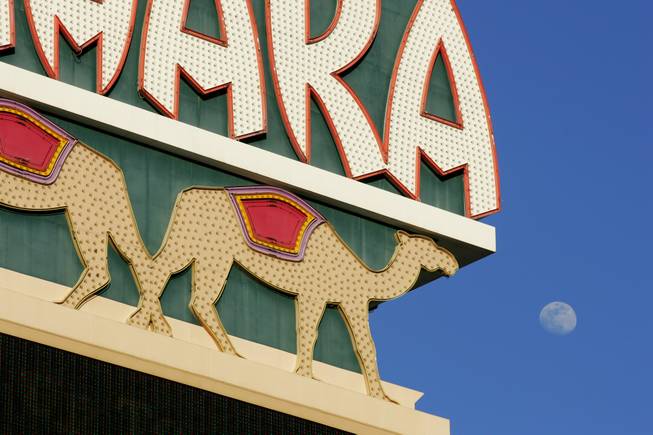 The moon rises behind the Sahara marquee on Las Vegas ...