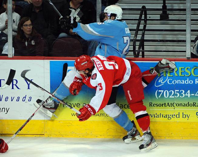 Wrangler forward Chad Nehring checks Alaska Aces defenseman Sean Curry into the boards during the second period of play on Saturday night.