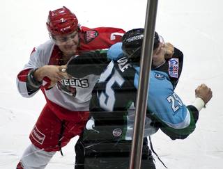 Las Vegas Wranglers forward Alexandre Mentink (7) fights Alaska Aces defenseman Dustin Molle (25) in the opening seconds of the first period on Sunday afternoon at the Orleans Arena.