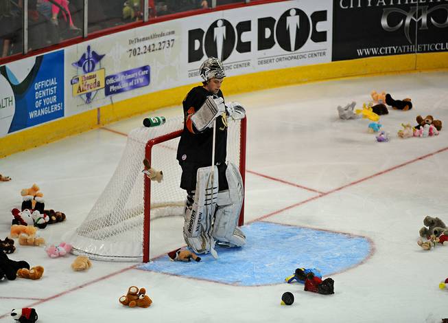 San Francisco Bulls goaltender Tyler Beskorowany stands in his crease as plush animal toys rain down to the ice after Wranglers forward Matt Tassone scored the first goal of the game for Las Vegas during the third period on Sunday afternoon at the Orleans Arena.
