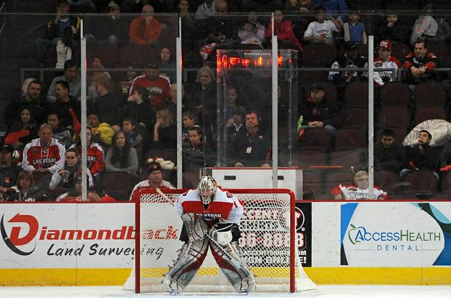 Fans look on from behind the glass as Las Vegas Wranglers goaltender Mitch O'Keefe stands in his goal after giving up a breakaway goal to the San Francisco Bulls during the second period of play on Sunday afternoon.