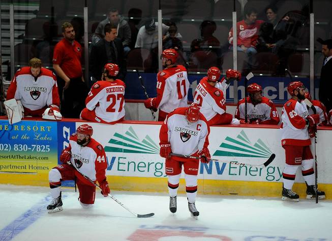 Las Vegas Wranglers players linger around their bench during the third stoppage in play of the first period due to plexiglass problems in an ECHL game against the Bakersfield Condors at the Orleans Arena on Friday night.