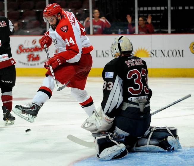 Las Vegas Wranglers defenseman Nolan Julseth-White lifts his skate as a shot comes in from the point towards Bakersfield Condors goaltender Chet Pickard during an ECHL game at the Orleans Arena on Friday night.