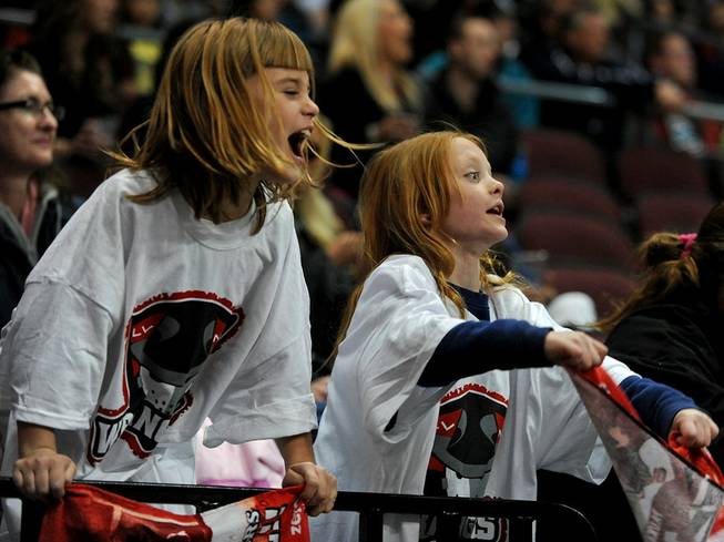 Hockey fans Aubrey Murphy, 7, left, and Katelyn Limes, 10, cheer on the Wranglers to a 3-1 victory over the Bakersfield Condors at the Orleans Arena on Friday night. The announced attendance was 7,008.