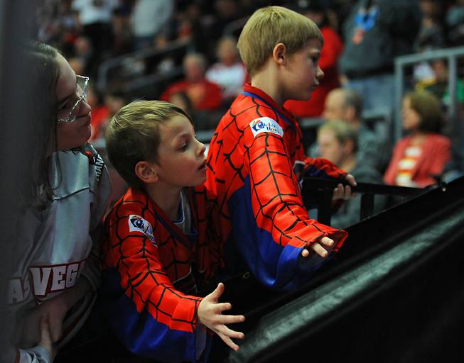 Young Wrangler fans look to high-five players coming onto the ice for the third period of play between Las Vegas and the Idaho Steelheads on "Spiderman Night" at the Orleans Arena on Saturday night.