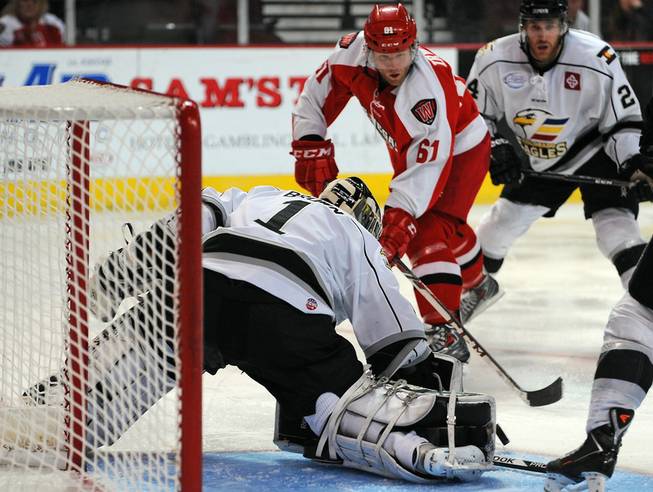 Colorado Eagles goaltender Adam Brown stops a shot from Las Vegas Wranglers forward Geoff Irwin (61) during the second period on Tuesday night at the Orleans Arena.