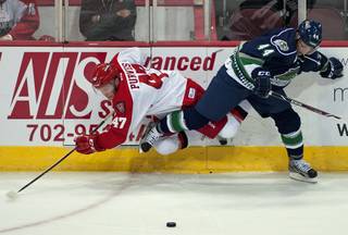 Las Vegas Wranglers right wing Cody Purves (47) gets tripped up by Florida Everblades defenseman Olivier Dame-Malka (44) during an ECHL game at the Orleans Arena on Tuesday night.