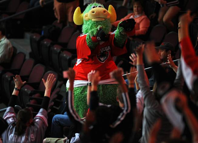 Las Vegas Wranglers mascot "The Duke" passes out hats to cheering fans during a stoppage in play between the Wranglers and the Bakersfield Condors on "Fan Appreciation Night" on Tuesday night.