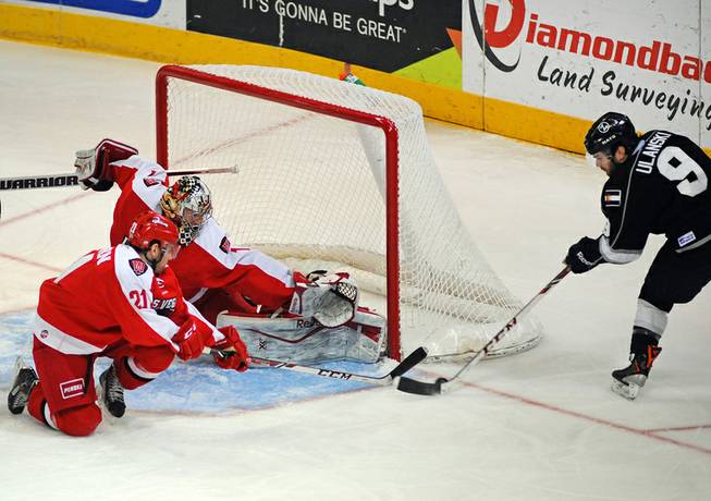 Las Vegas Wranglers goaltender Mitch O'Keefe covers the post with a pad to stop a scoring attempt by Colorado Eagles forward Kevin Ulanski during the first period on Tuesday night.