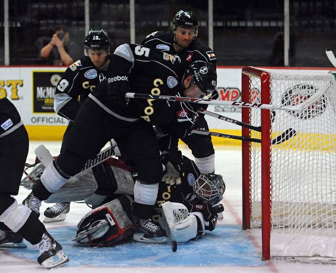 With Colorado goaltender Dustin Butler out of position, Eagles forward Trent Daavettila looks to shoot a loose puck out of the crease during a second period scoring attempt on Tuesday night.