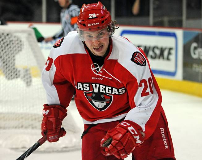Las Vegas Wranglers forward Robbie Smith keeps his eyes on a puck as it bounces along the boards during an ECHL game against the Colorado Eagles on Tuesday night.