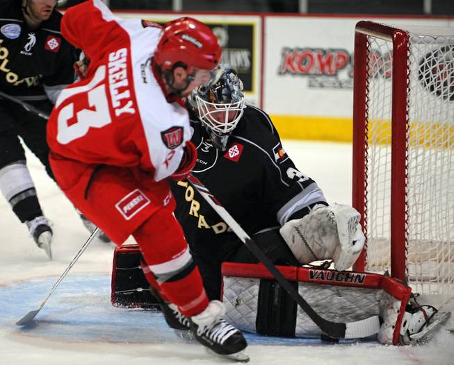 Colorado Eagles goaltender Dustin Butler stops Las Vegas Wranglers winger Shawn Skelly on a breakaway during the second period of play on Tuesday night.