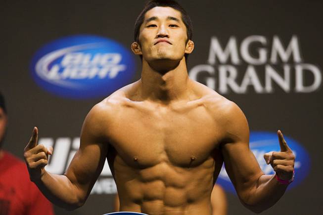 Welterweight fighter Dong Hyun Kim poses on the scale during the UFC 141 weigh-in at the MGM Grand Garden Arena Thursday, Dec. 29, 2011.