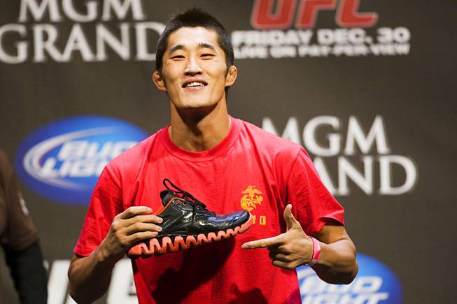 Welterweight fighter Dong Hyun Kim shows off his shoes during the UFC 141 weigh-in at the MGM Grand Garden Arena Thursday, Dec. 29, 2011.