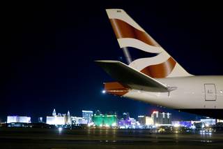 Las Vegas Strip casinos are shown behind a British Airways' B777 passenger jet during the arrival of an inaugural flight for British Airways at McCarran International Airport in Las Vegas, Sunday, Oct.  25, 2009. The new daily non-stop service is between London's Heathrow Airport and Las Vegas. 
