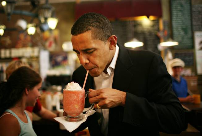 Sen. Barack Obama tries a house favorite, a strawberry smoothie, while making a campaign stop at Comma Coffee Cafe in Carson City, Nevada, in May 2007.