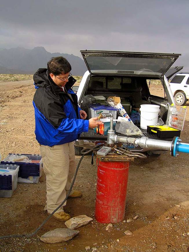 Duane Moser, a microbial and molecular ecologist at the Desert Research Institute, takes water samples from a well in California near Death Valley in 2007. Moser is part of a team of researchers that just received a $6.6 million NASA grant to explore life underground. The site will be one of the main land-based places of interest for the new study.