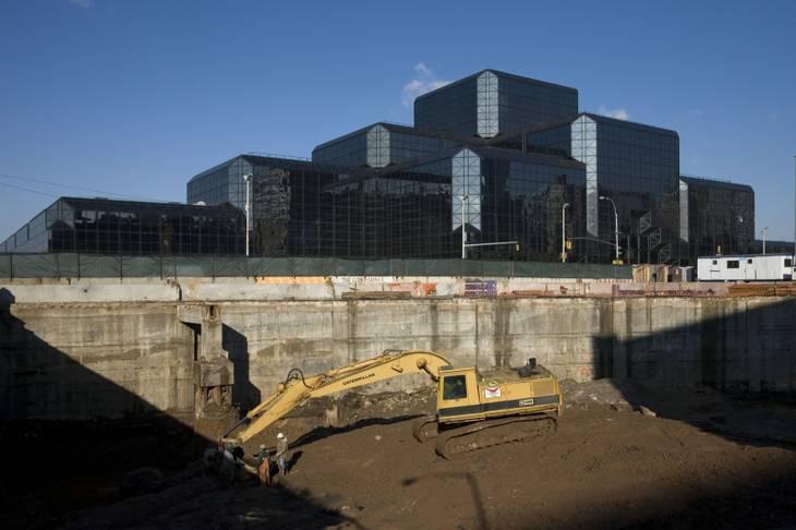 An excavator removes earth for the construction of the No. 7 subway line station adjacent to the Javits Covention Center in New York, in this Dec. 31, 2007 file photo. 